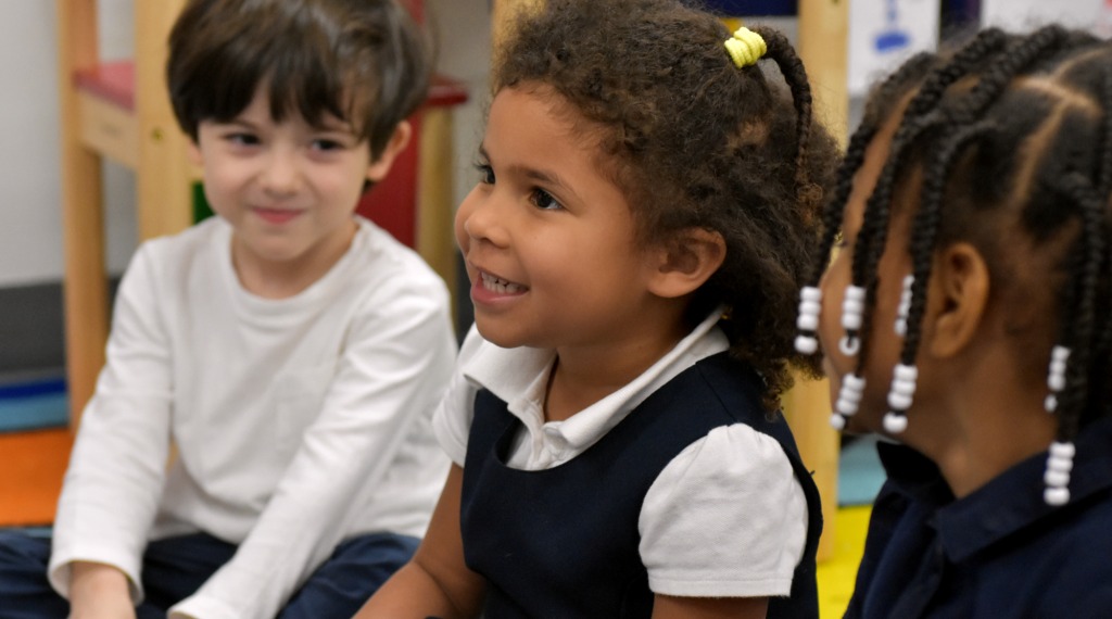 Children in classroom smiling
