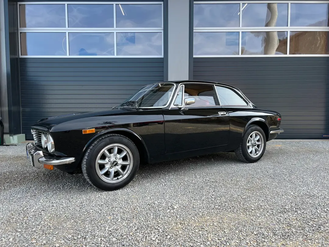Classic black car restoration in garage