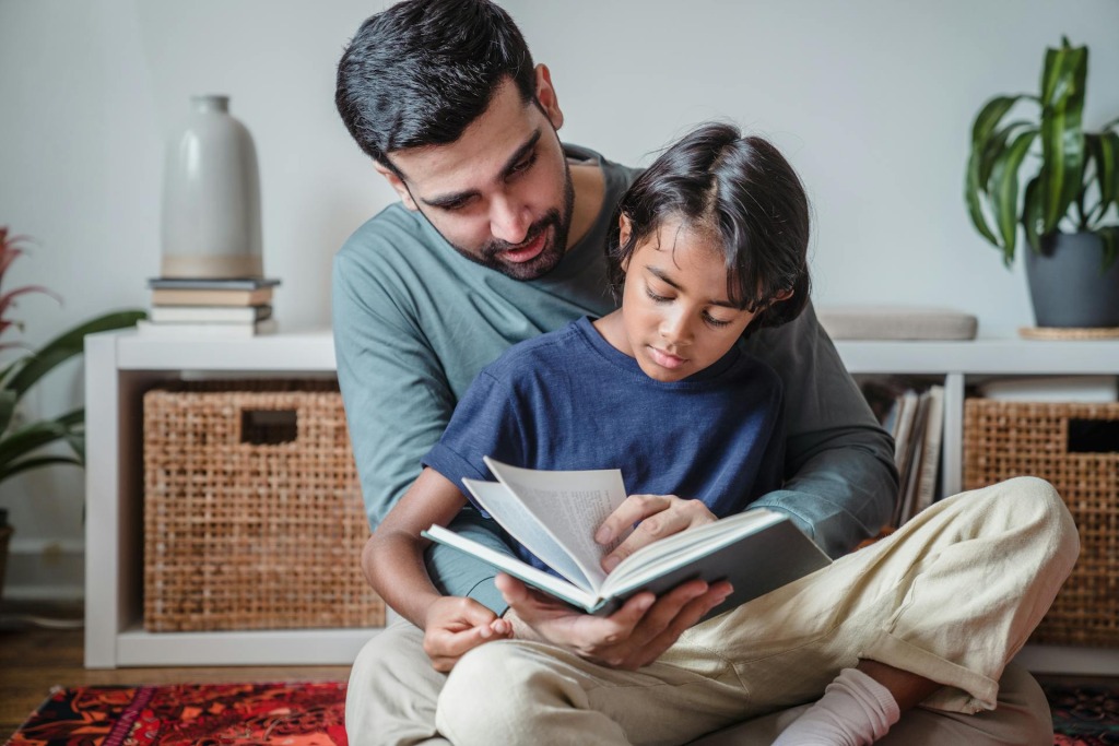 Father and daughter reading together