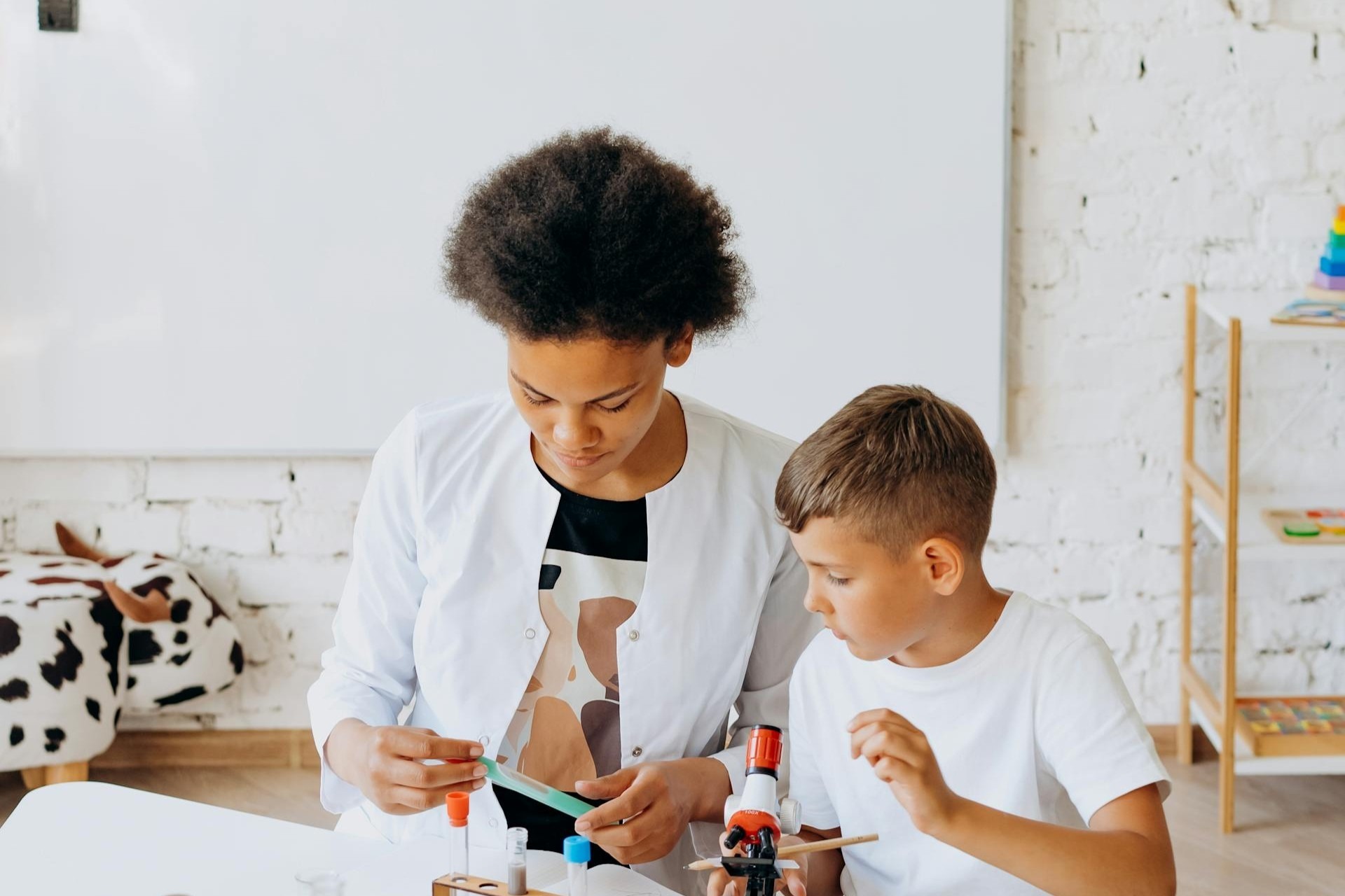 Teacher helping student with STEM activities