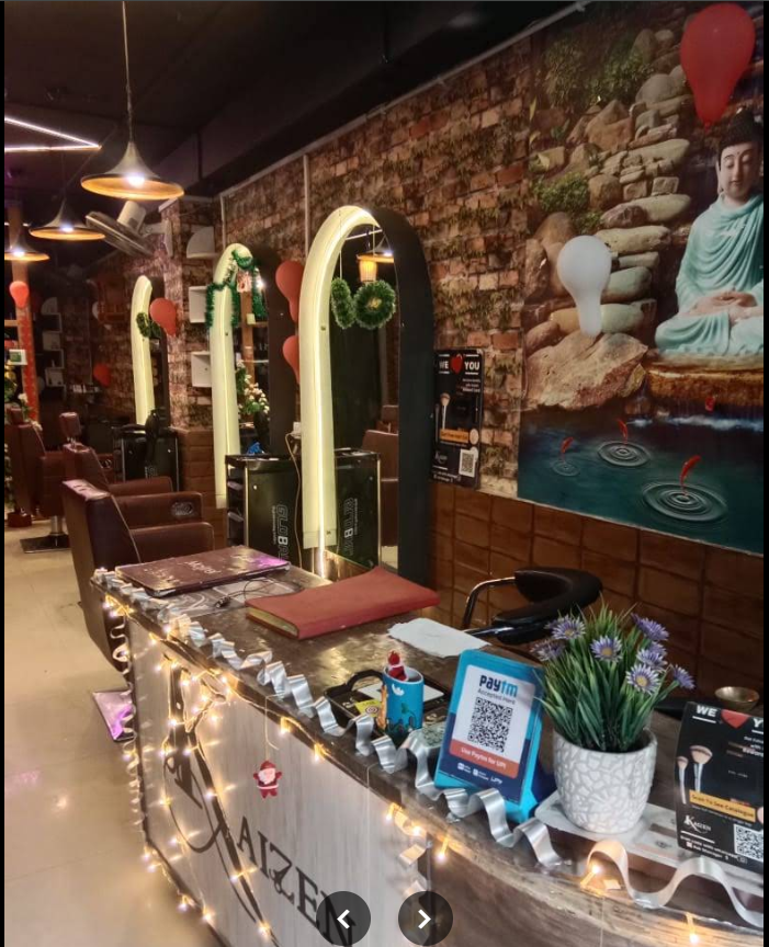Kaizen salon reception with Buddha mural and lit mirrors