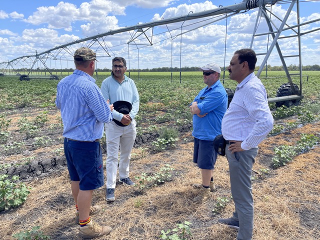Research team in a crop field with large center-pivot irrigation system