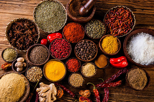 Colorful array of exotic spices and herbs in traditional bowls
