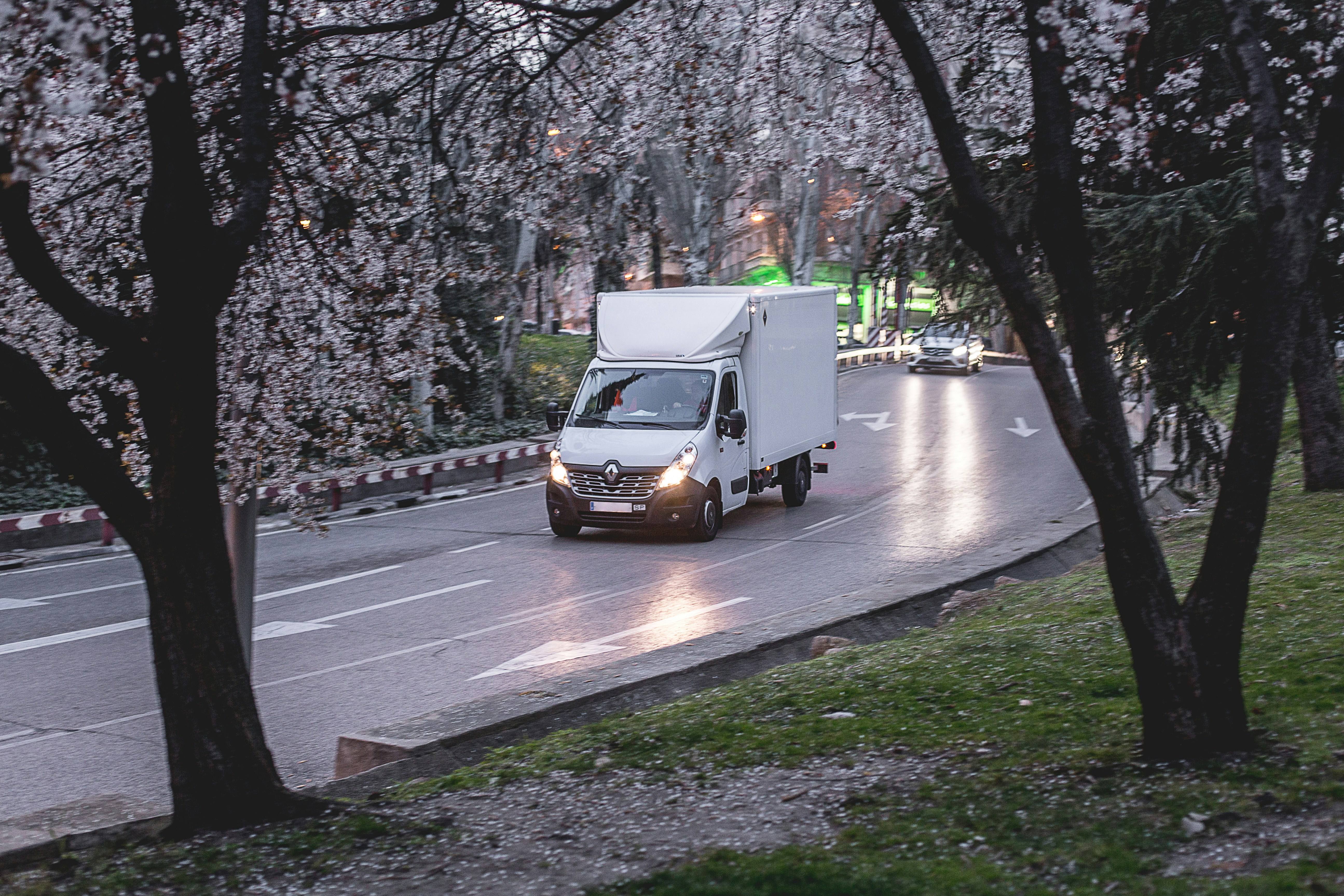 Professional moving truck on tree-lined Waunakee street