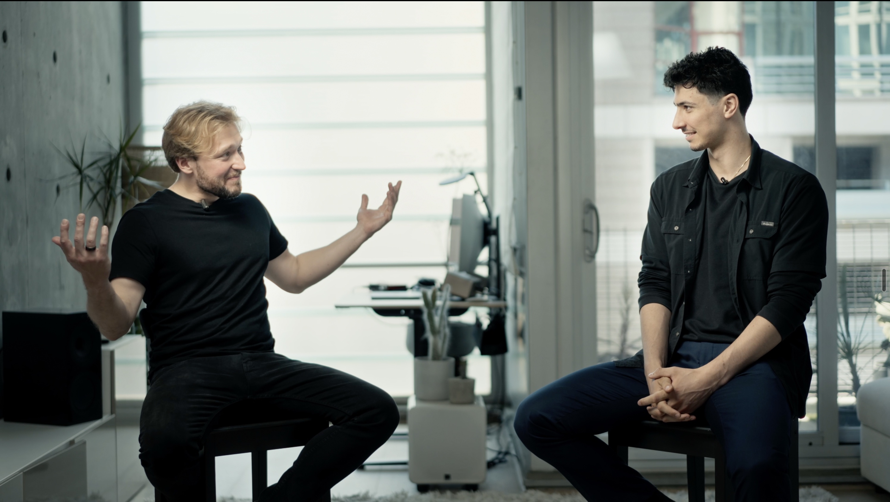 Joseph Weinerman and host Francisk Hanchar seated together in a bright studio conversation