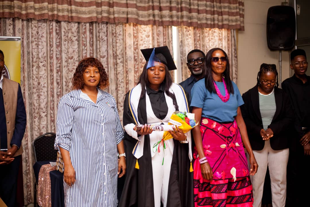July 2025 graduate with diploma and flowers
