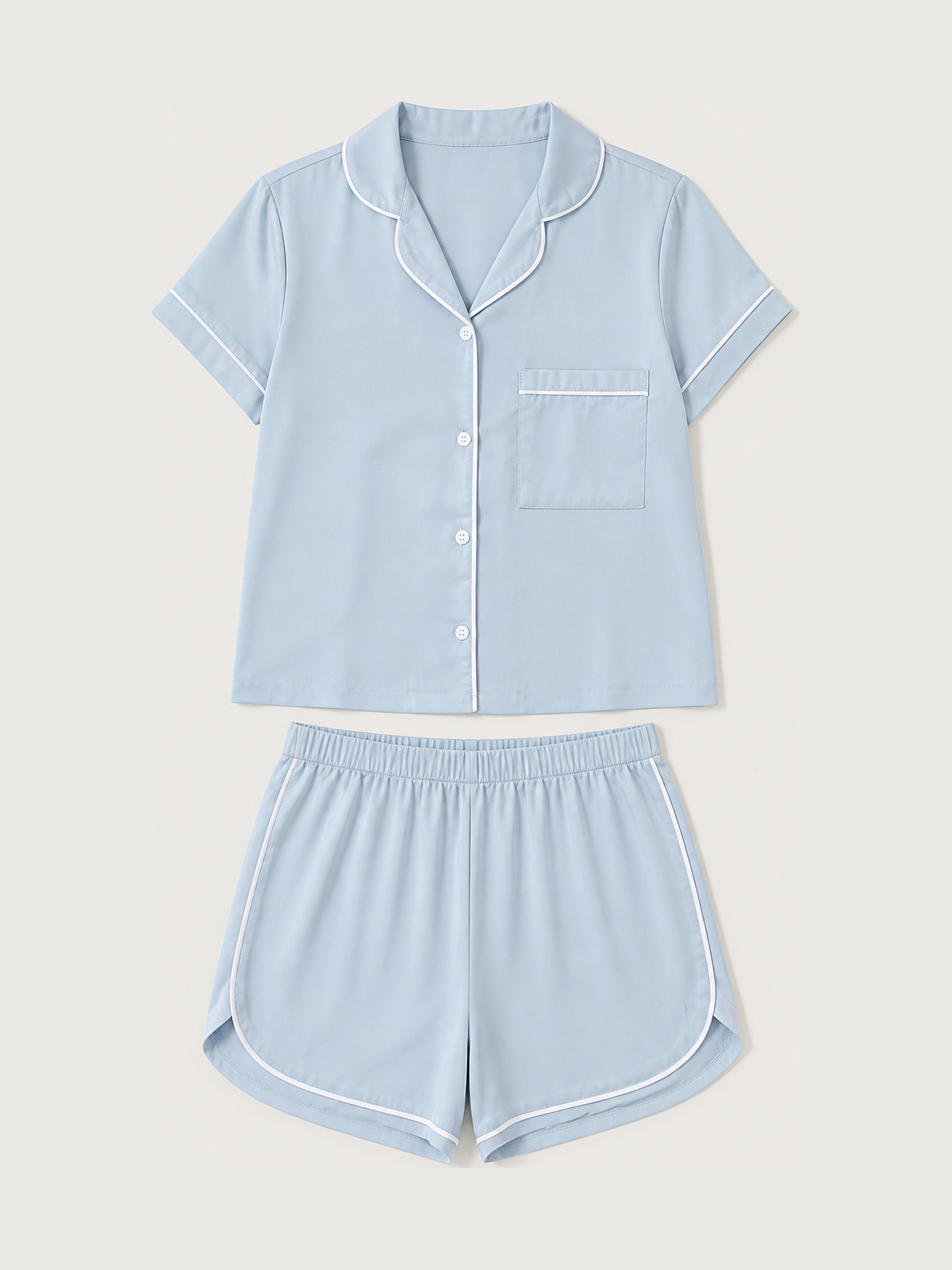 A satin light blue short-sleeve button-up pajama top with chest pocket, matching shorts, and crisp white piping.