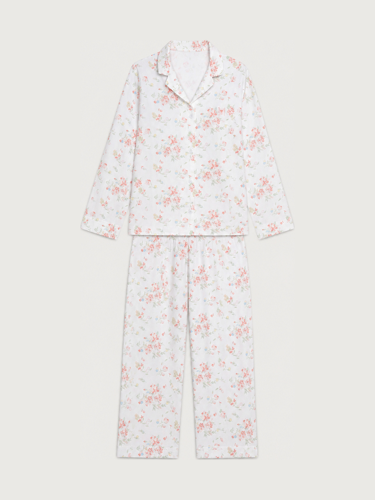 A satin matching long-sleeve button-front top and full-length pants in a soft pink floral print.