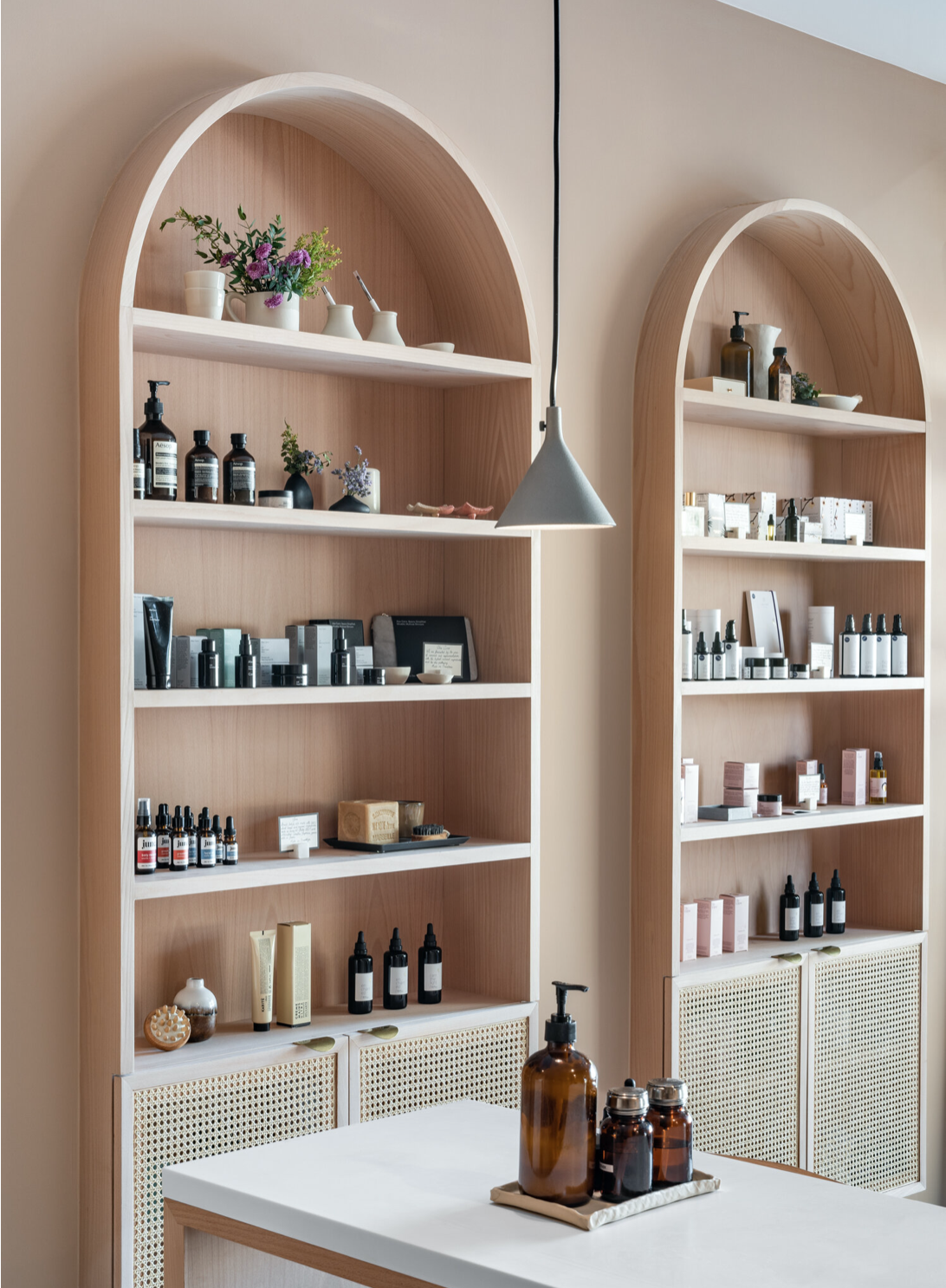 Detail of arched shelving units with carefully arranged wellness products