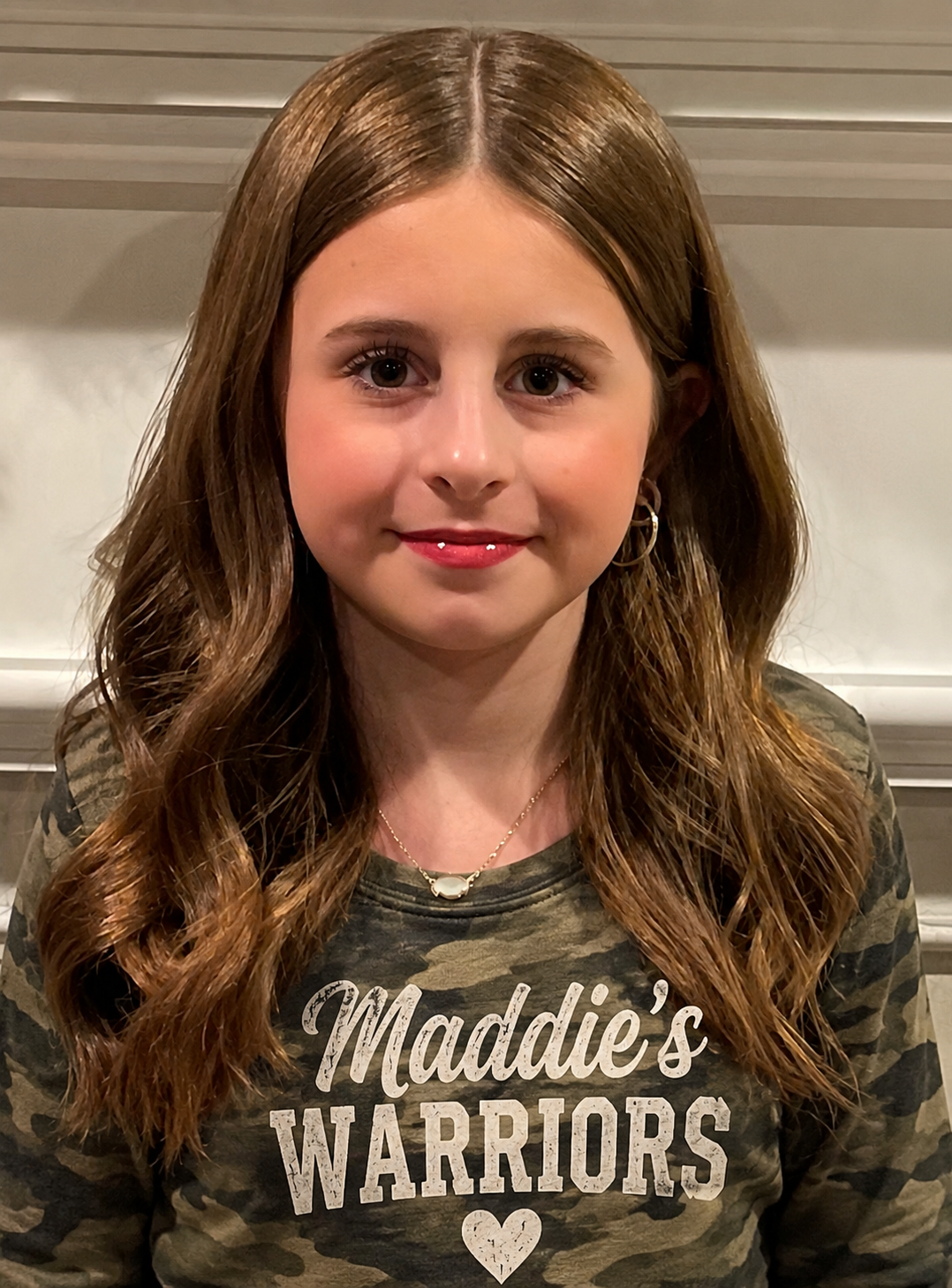 Maddie wearing her Maddie's Warriors camouflage shirt