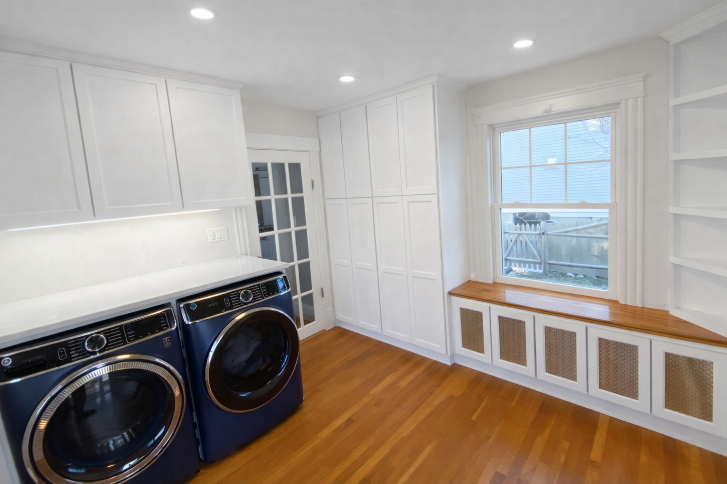 Custom laundry room with built-in cabinetry by Marblehead Carpentry