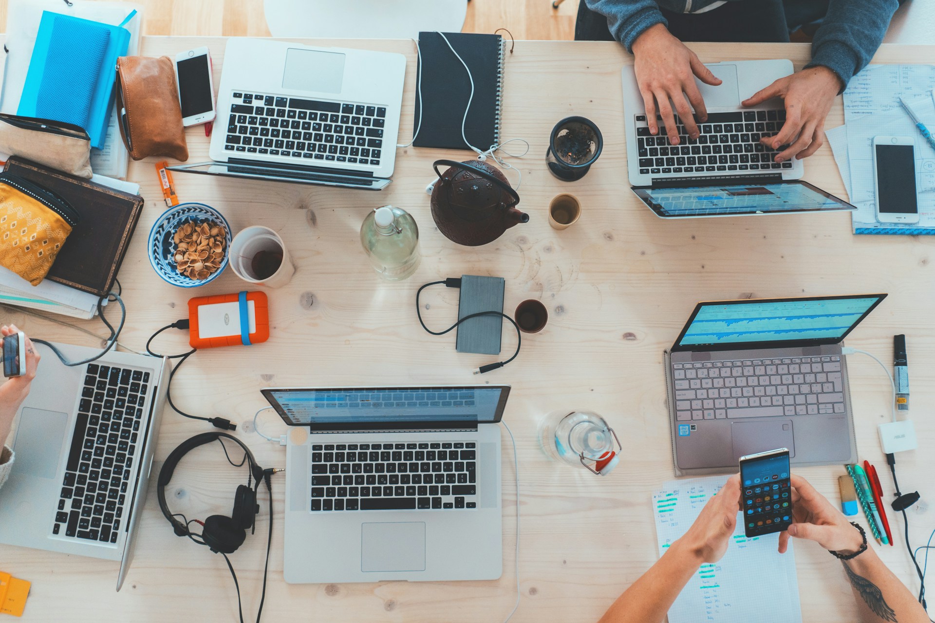 Modern workspace with laptops and tech accessories on a wooden desk