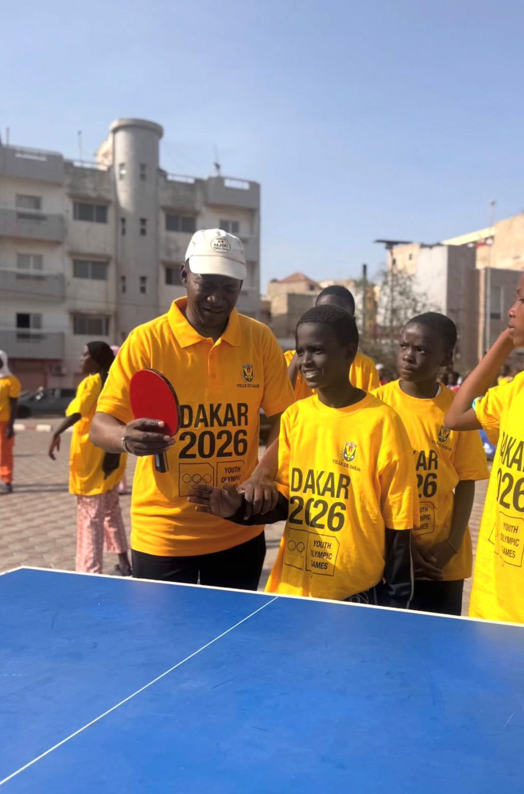Senegal youth table tennis players with Dakar 2026 banners