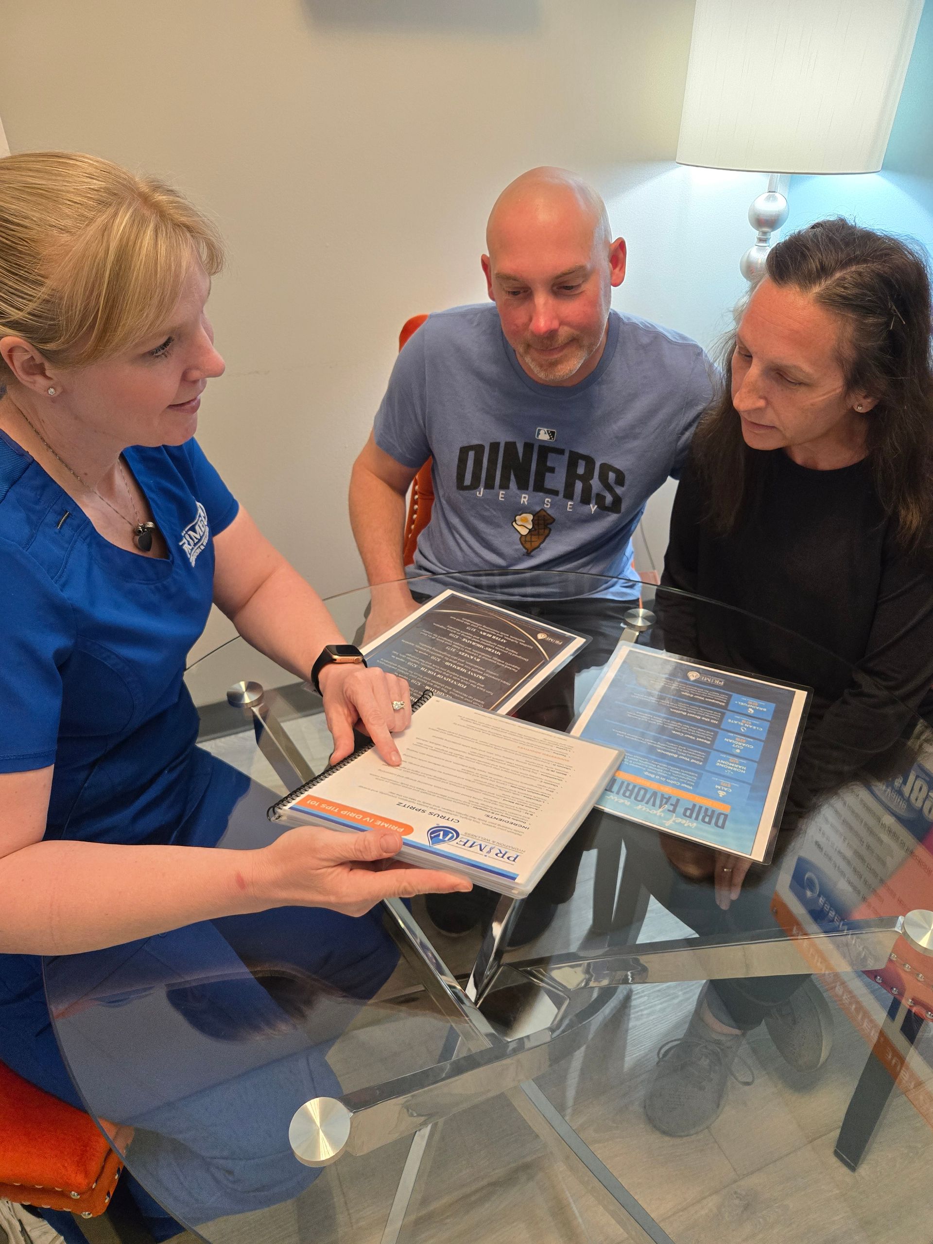 A Prime IV team member walking a couple through drip menus during a membership consultation