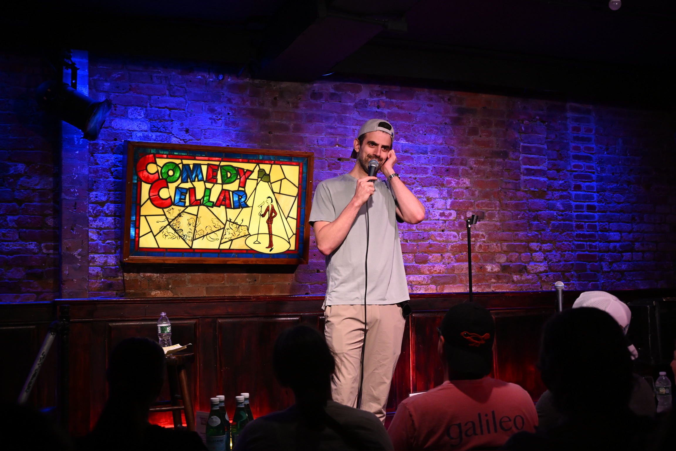 Sam Morril performing on stage at the Comedy Cellar