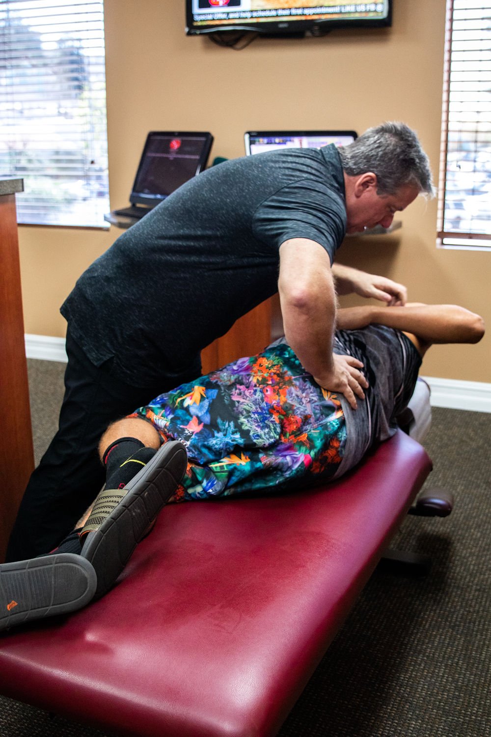 Dr. Gary B. Wright performing spinal adjustment treatment