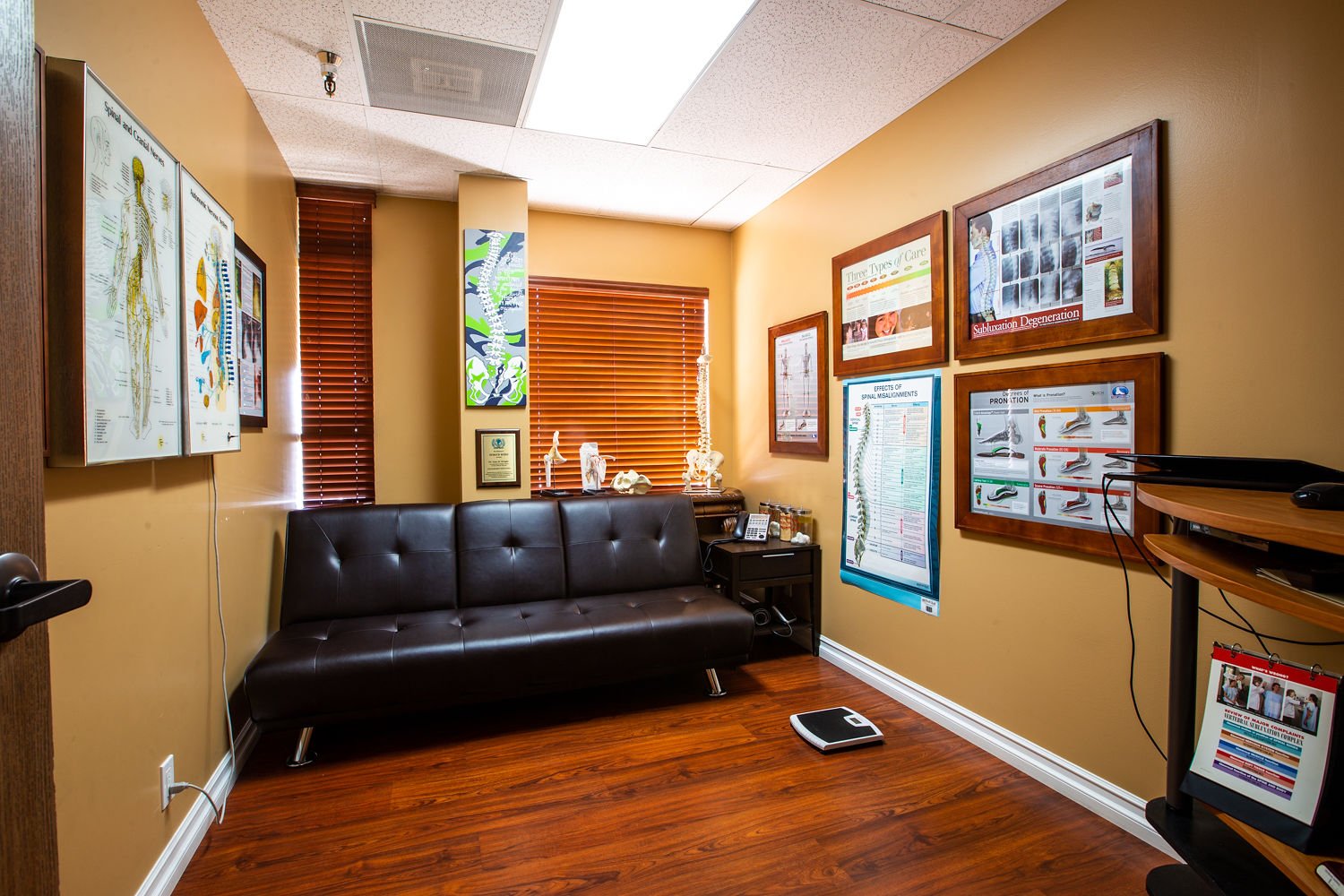 Consultation room with leather sofa and educational posters