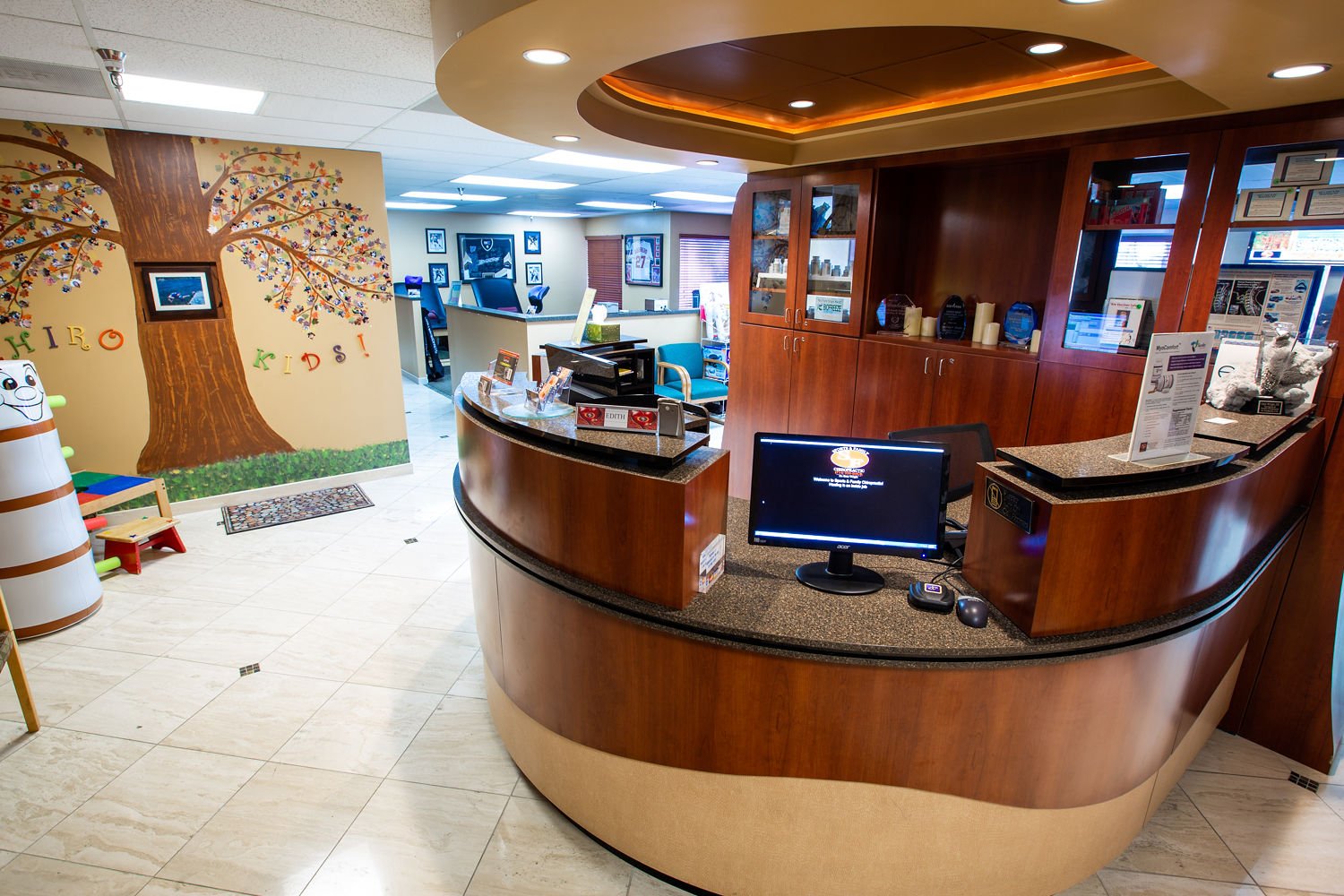 Kids area with colorful tree mural and play space
