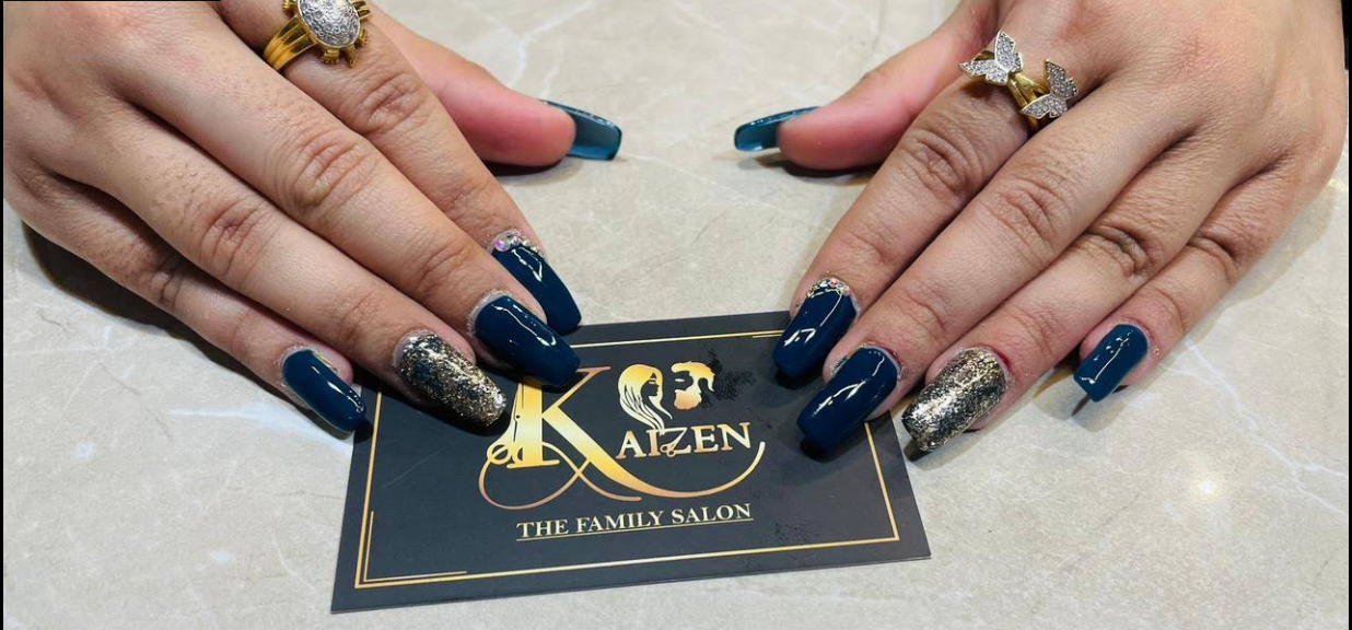 Blue and glitter nail art on a Kaizen business card