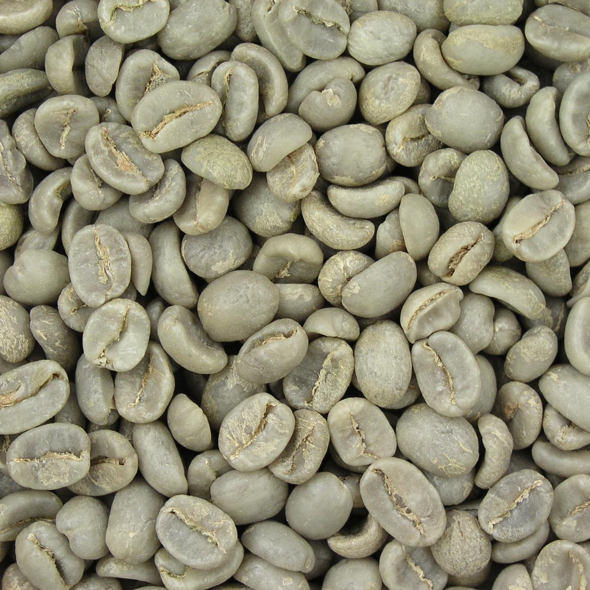 Pale green unroasted coffee beans filling the frame