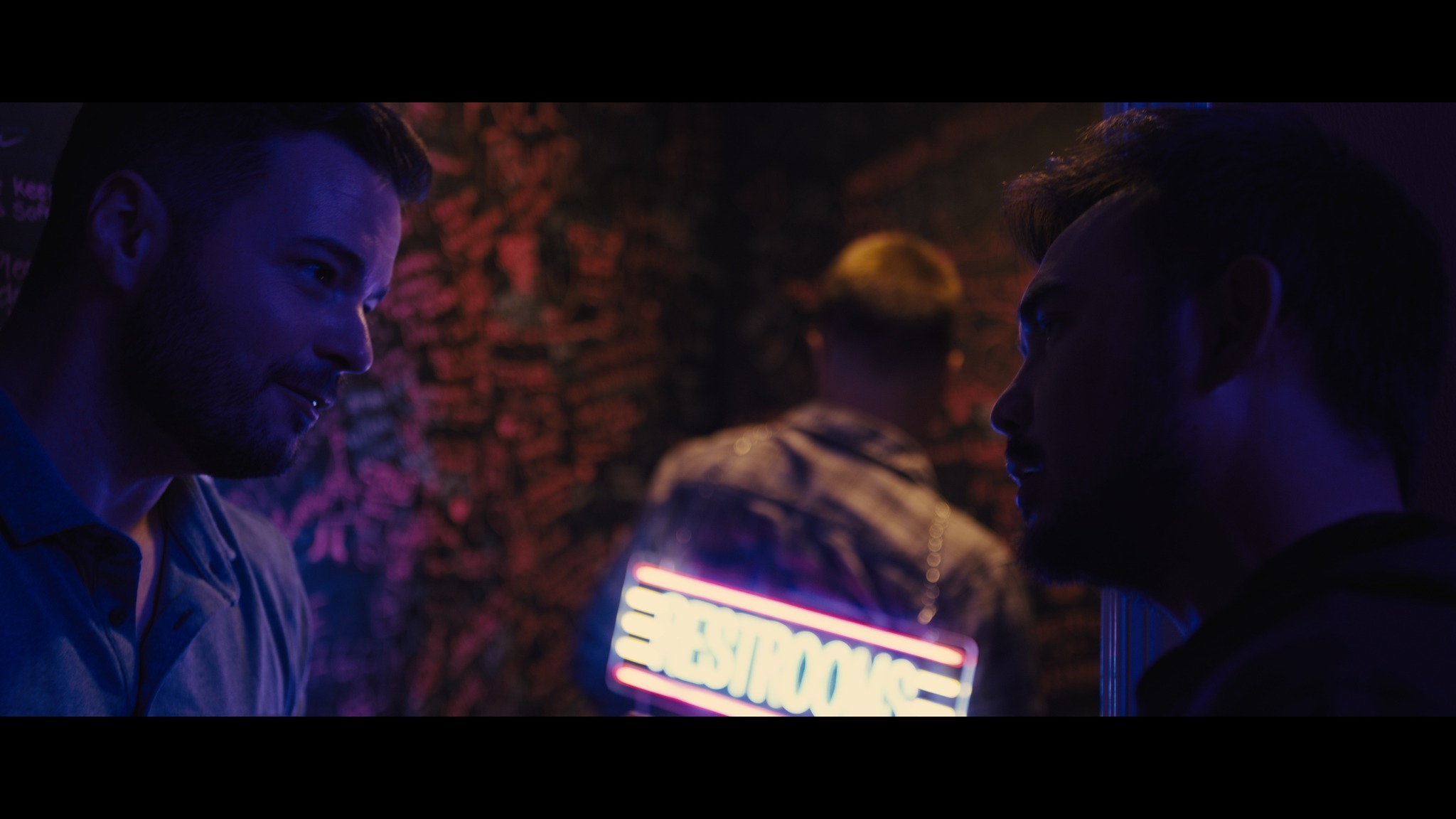 Group conversation at neon-lit venue