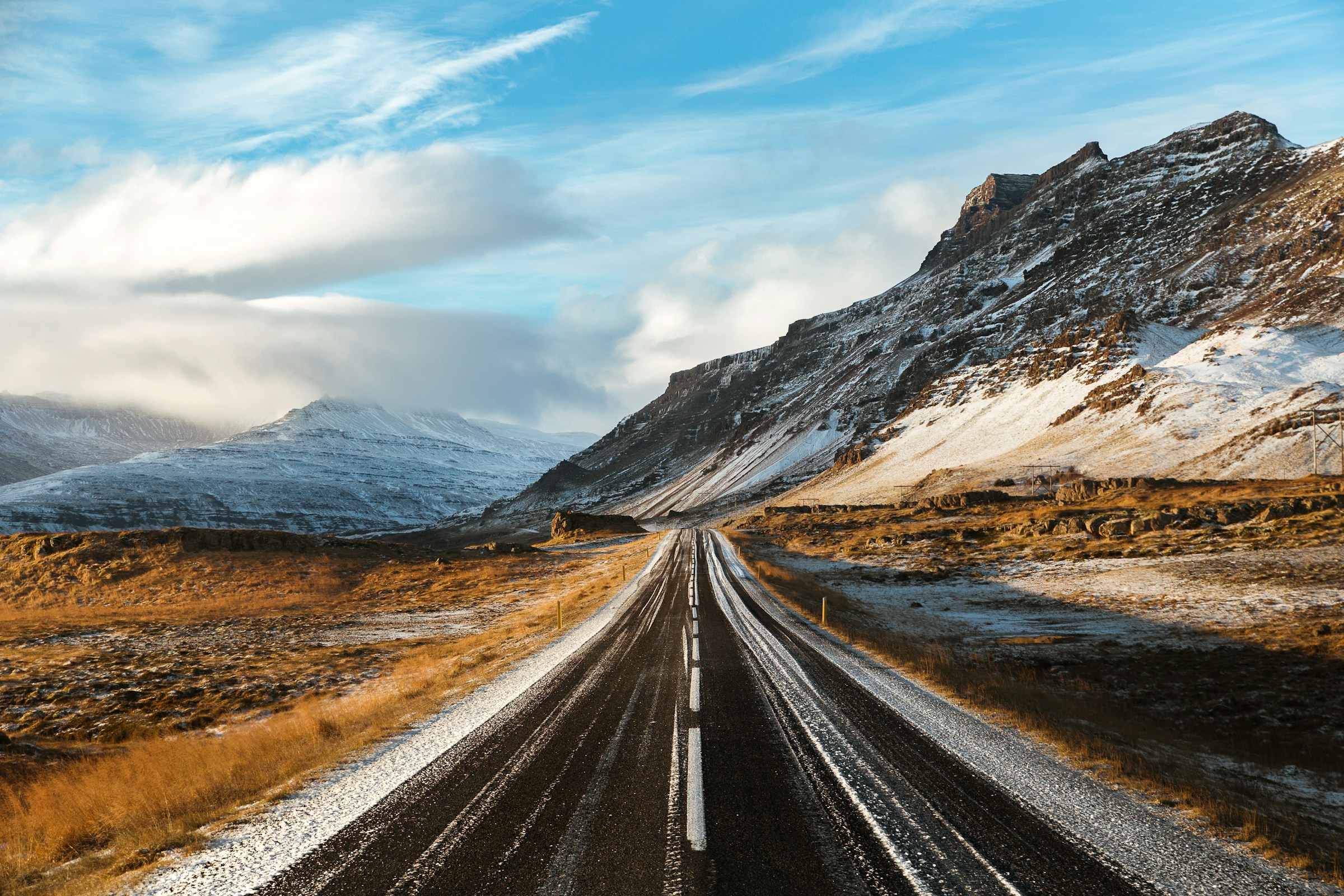 Road leading through snowy mountains representing navigation journey
