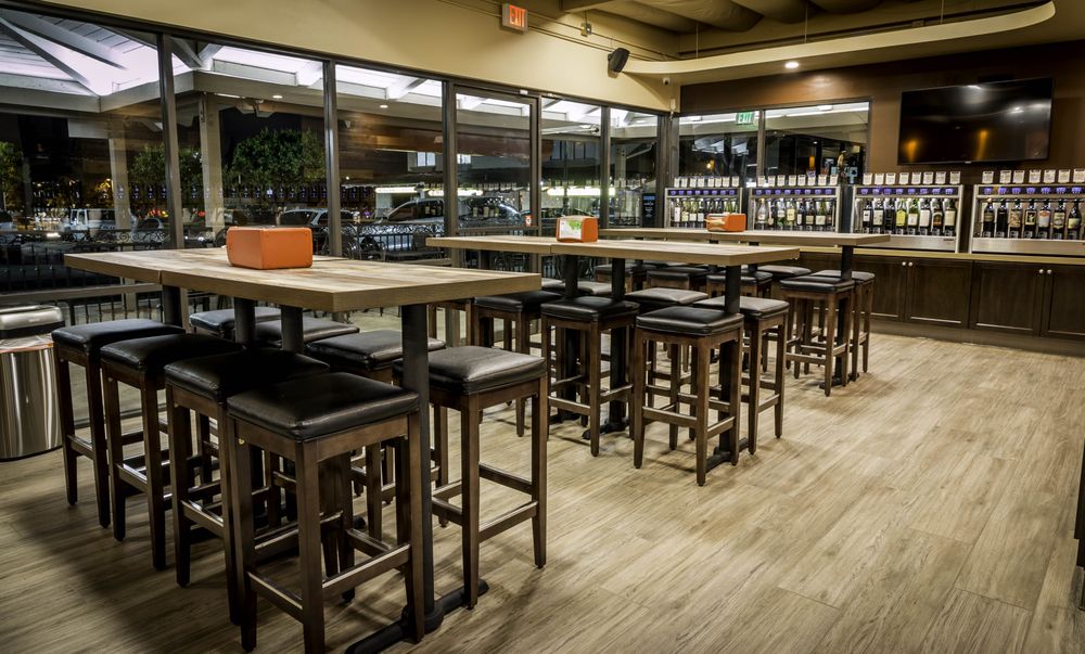 High-top tables and open gathering space inside Meritage Wine Mart