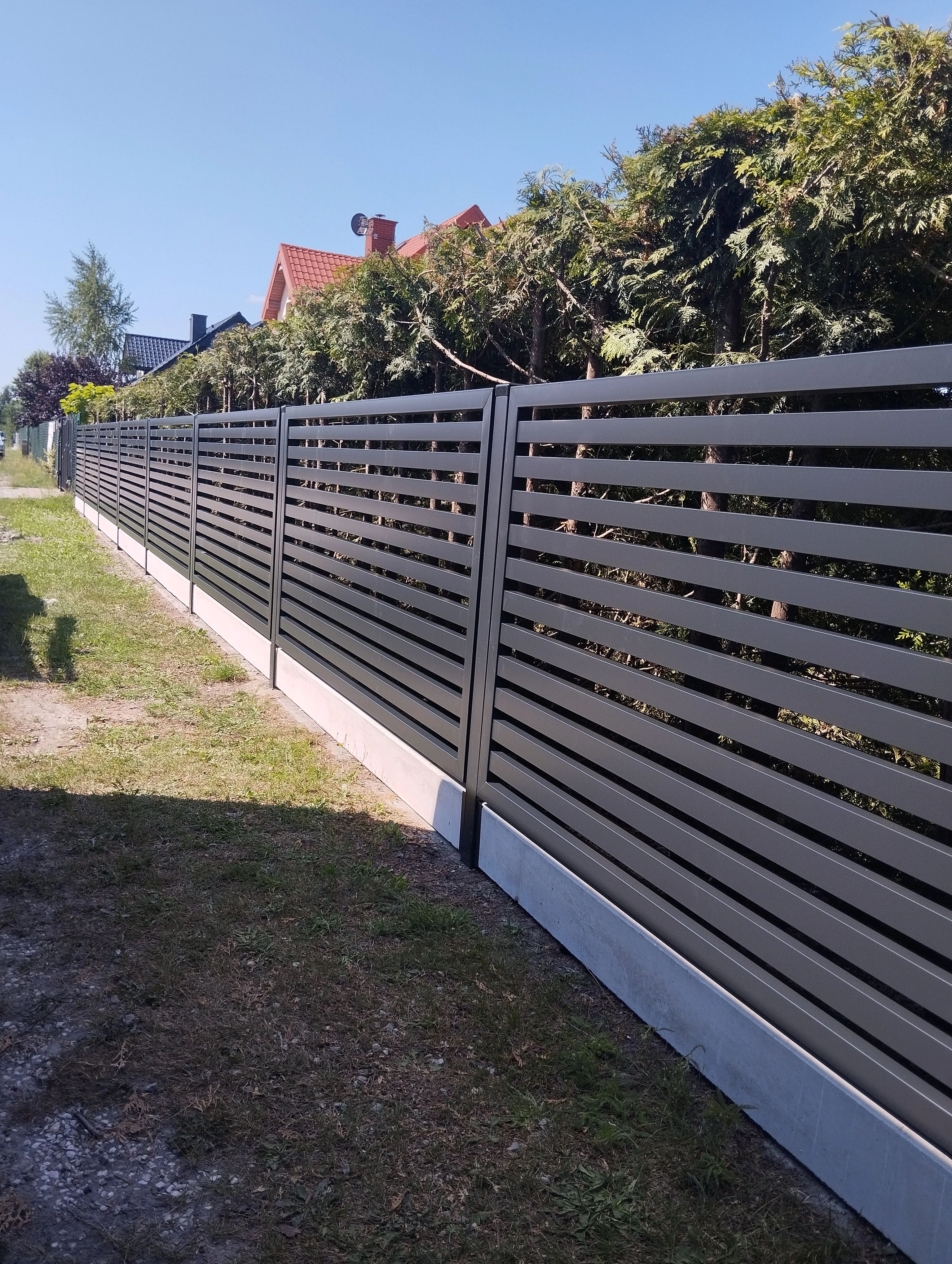 Horizontal slat fence in graphite color along property line