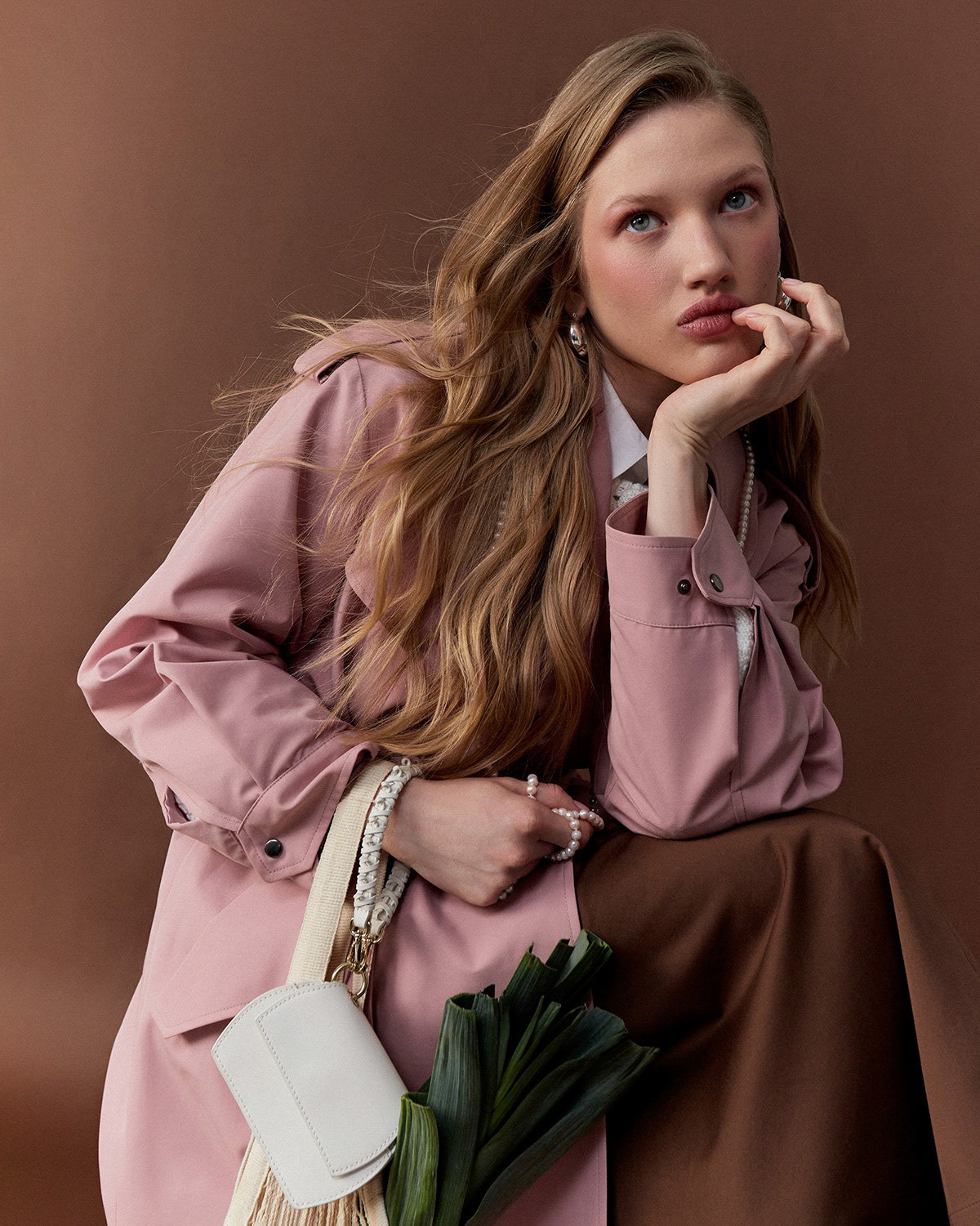 OnlyMe — pink coat, pearl jewellery, white mini bag, brown background