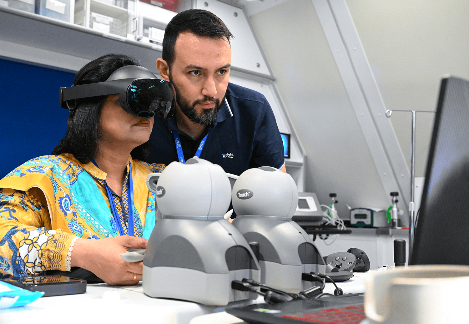 Ophthalmic surgeons training together on a haptic simulator in a hospital setting
