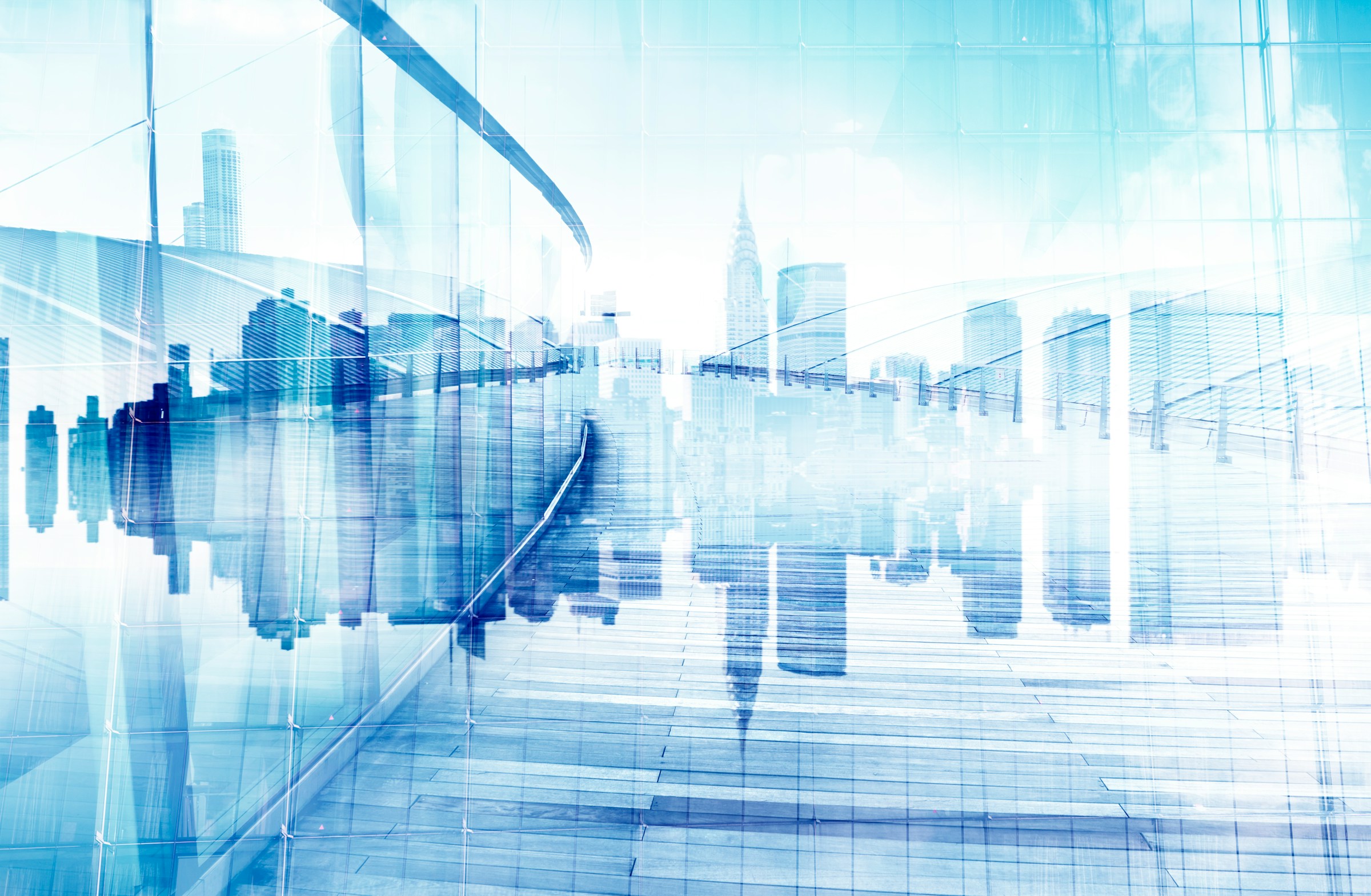 Double exposure of NYC skyline with glass building reflecting urban finance district