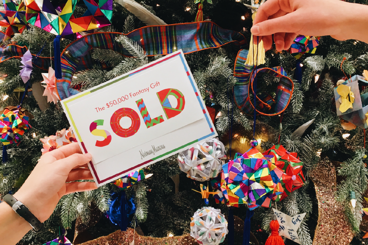 Neiman Marcus SOLD card held in front of an origami Christmas tree