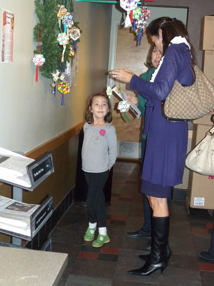 Isabelle Adams with a customer admiring origami ornaments at Starbucks