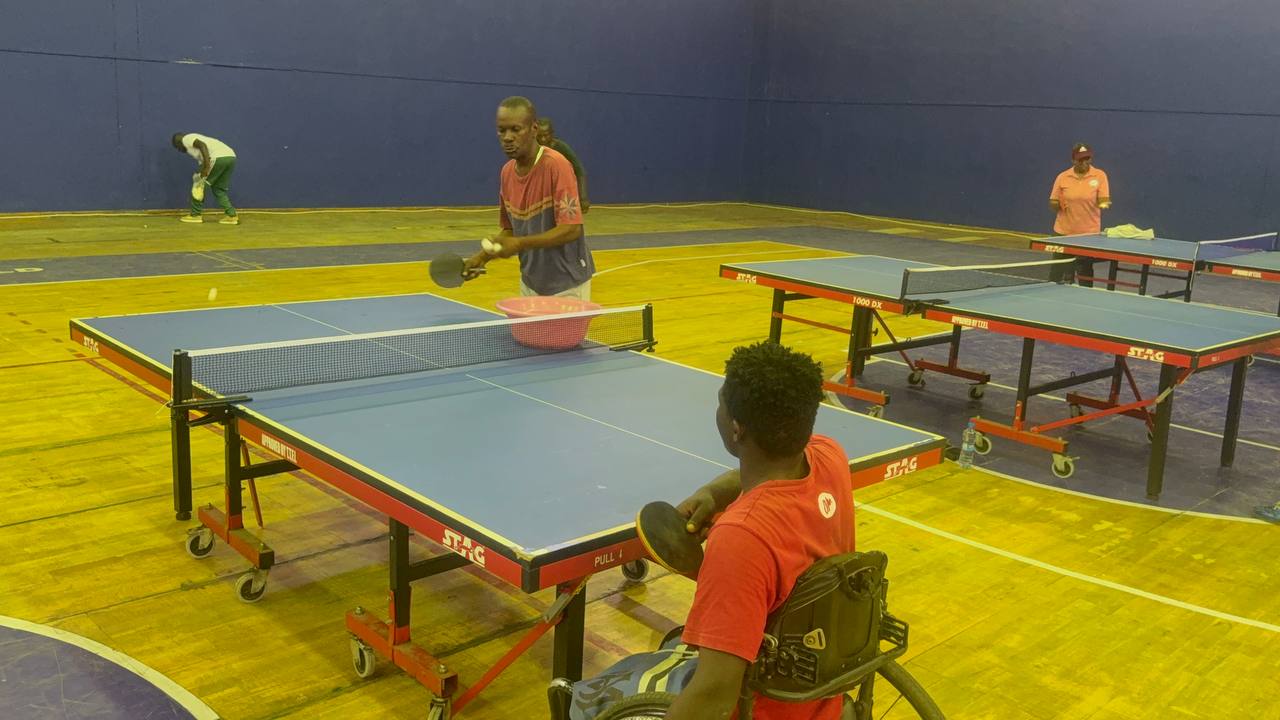 Para table tennis training session with a wheelchair player practicing with a coach