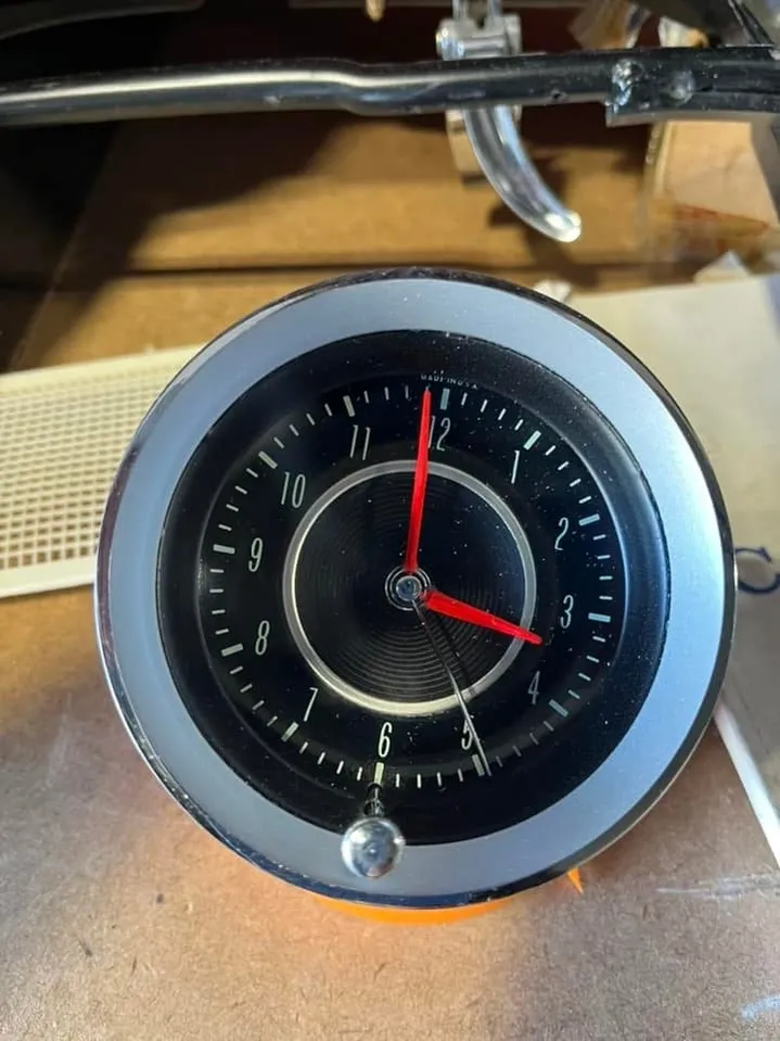 Original classic car clock gauge with chrome bezel and red hands