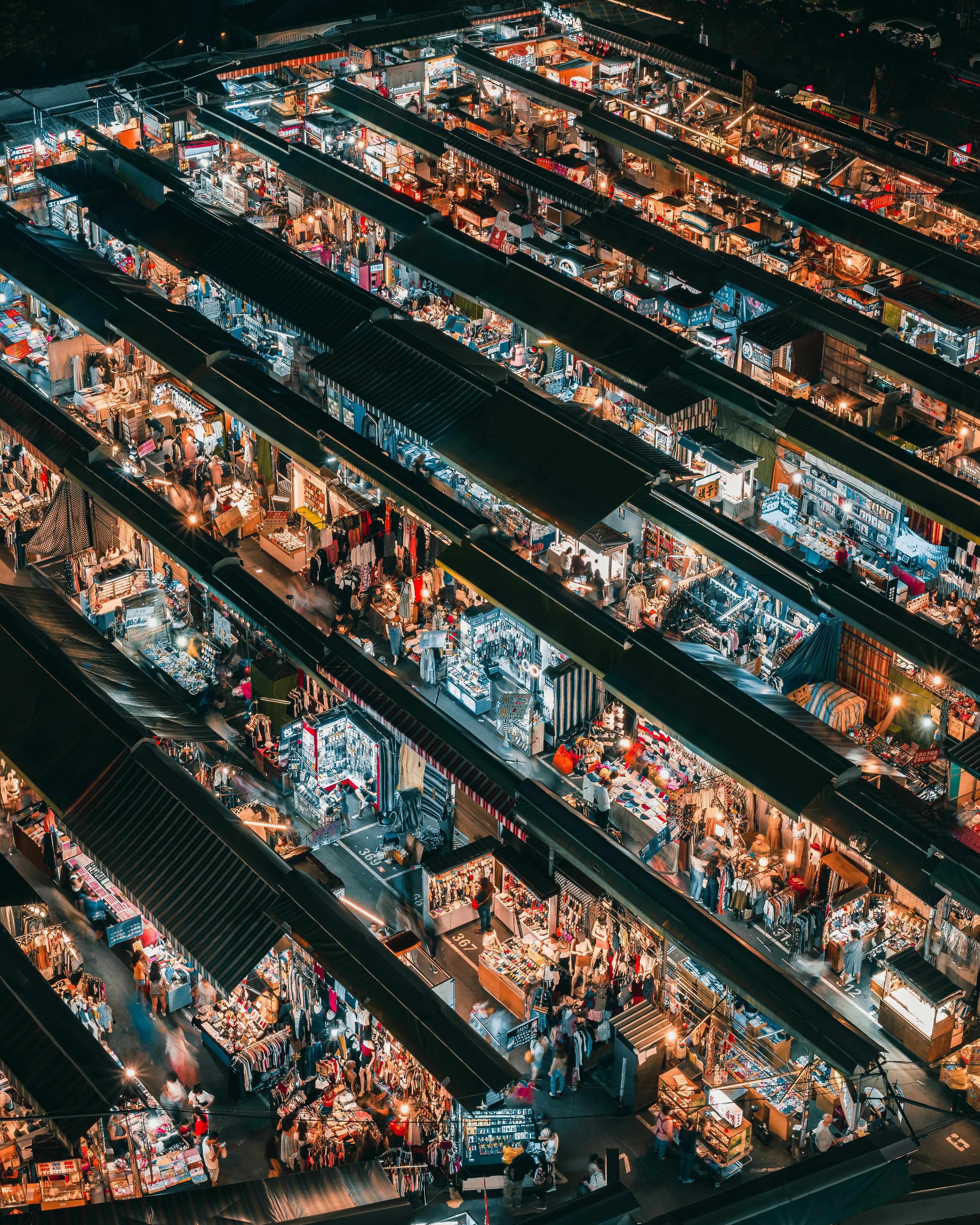 Aerial overhead view of market stalls and retail density