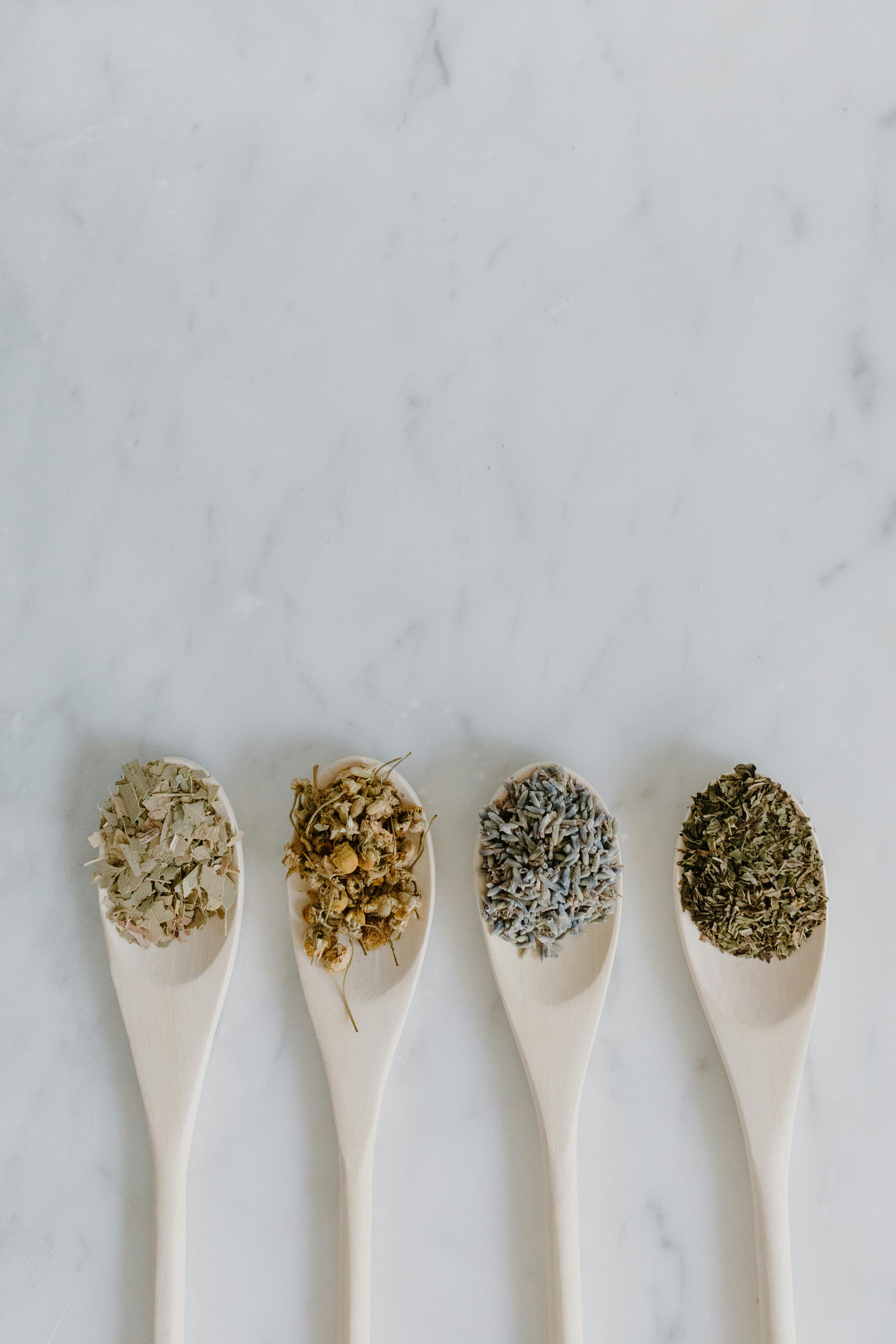 Wooden spoons with dried healing herbs