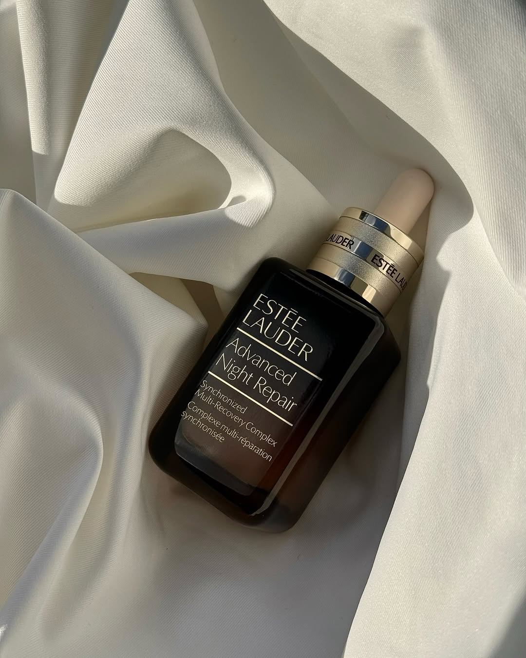 Estée Lauder Advanced Night Repair serum on white silk
