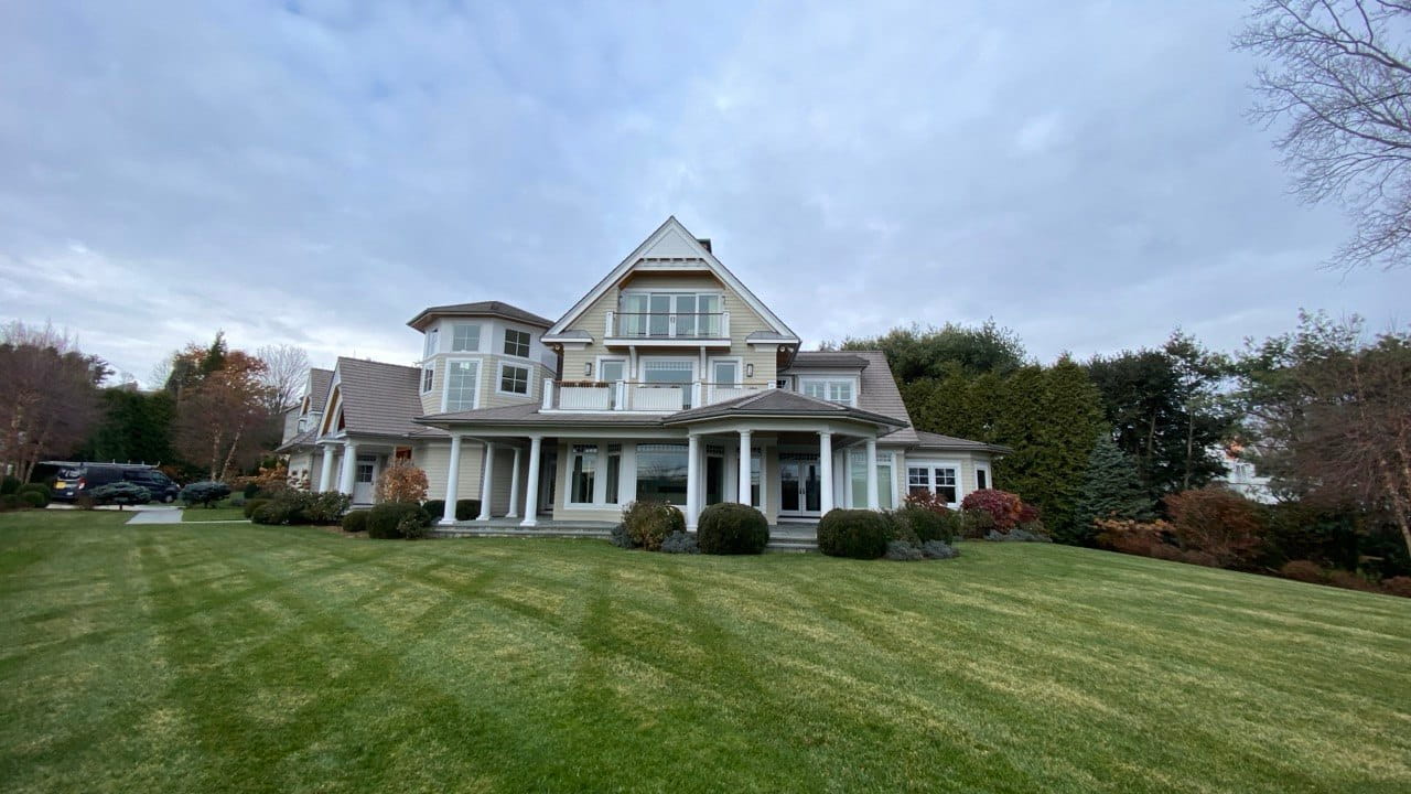 Gutter replacement on large New England estate with columned porch and manicured grounds — Connecticut