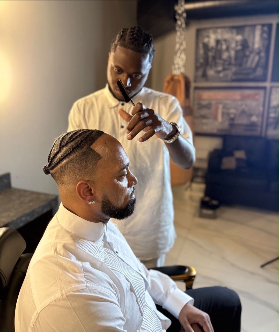 Braided cornrows with fade and beard detailing in studio