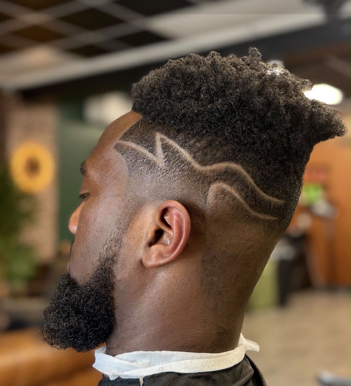 Intricate freehand design work carved into a fade