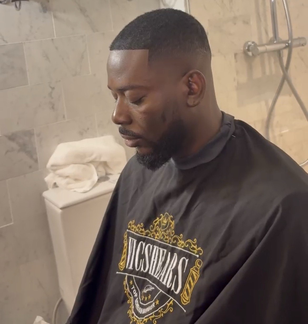 Clean fade and lineup finished in a marble bathroom suite