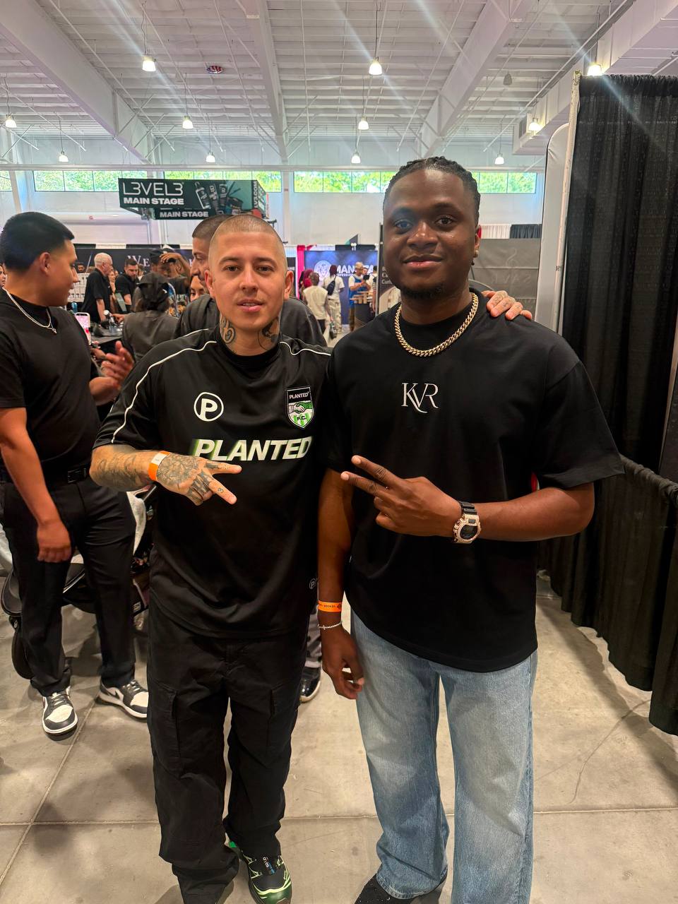 Two clients at professional barber convention with Level3 signage