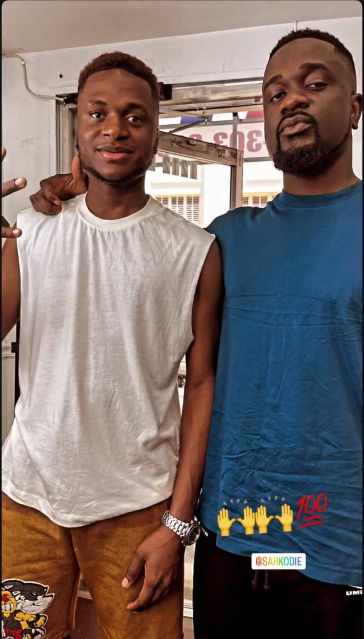 Two clients showing off fade designs in lounge