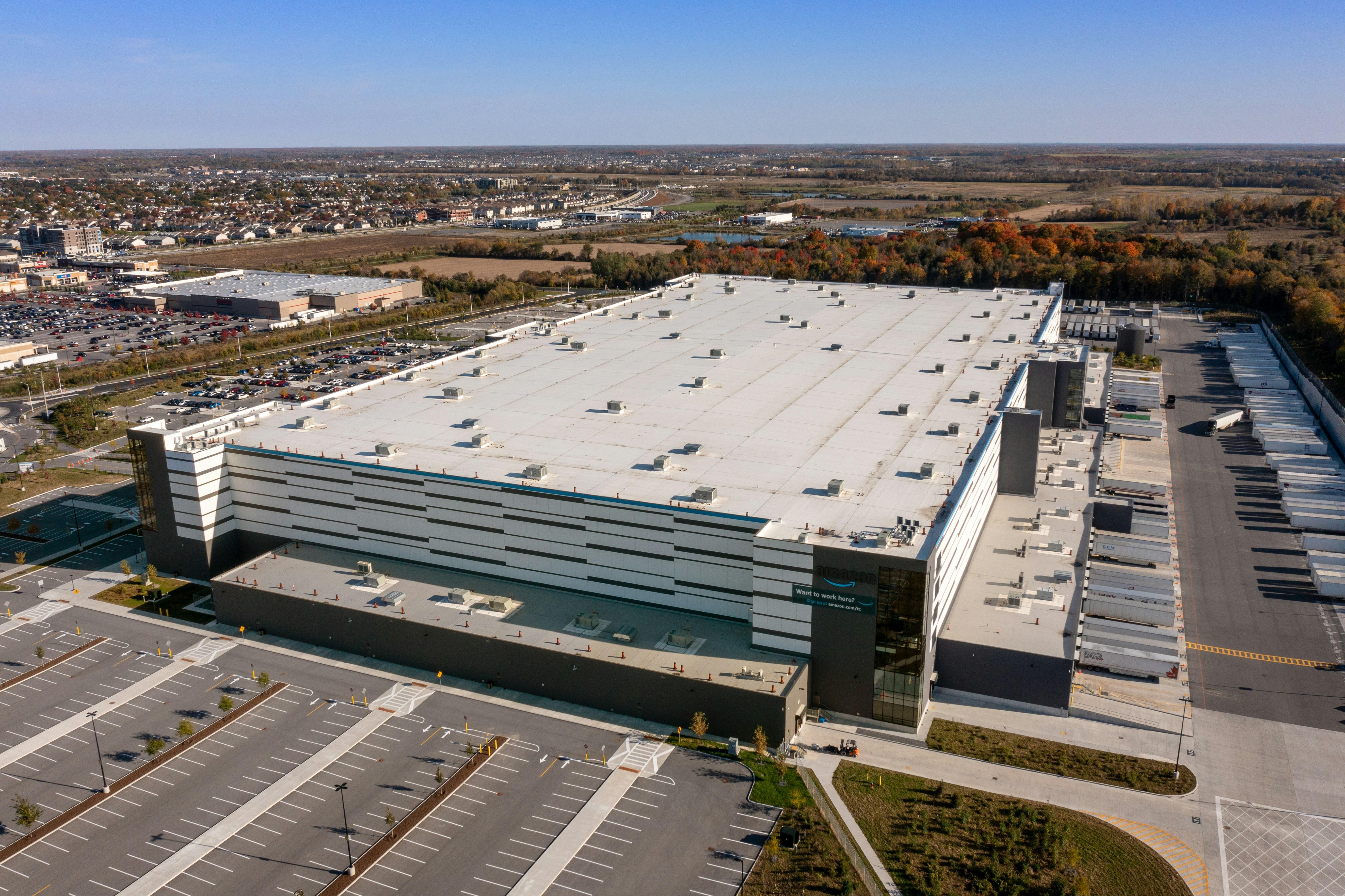 Commercial warehouse facility with flat roof and organized parking lot