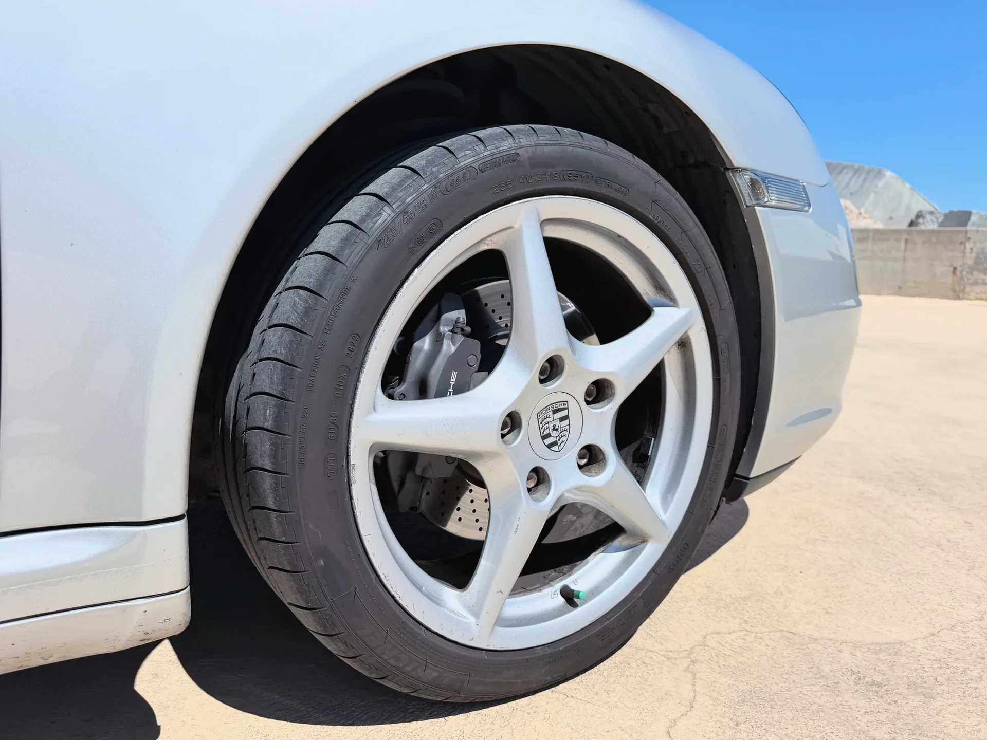 Close-up of the Porsche five-spoke alloy wheel and tire