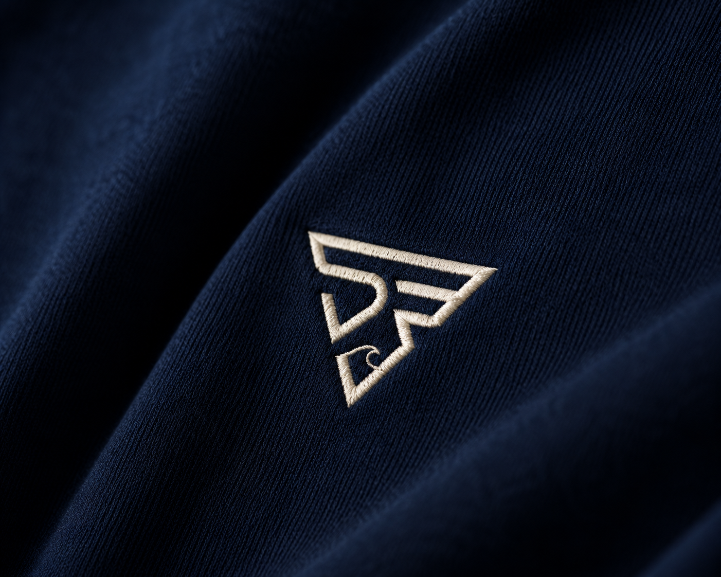 STIRUX embroidered logo detail — premium craftsmanship on navy fleece