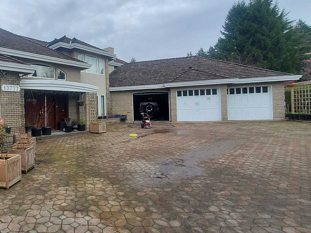 Large paved property area before pressure washing