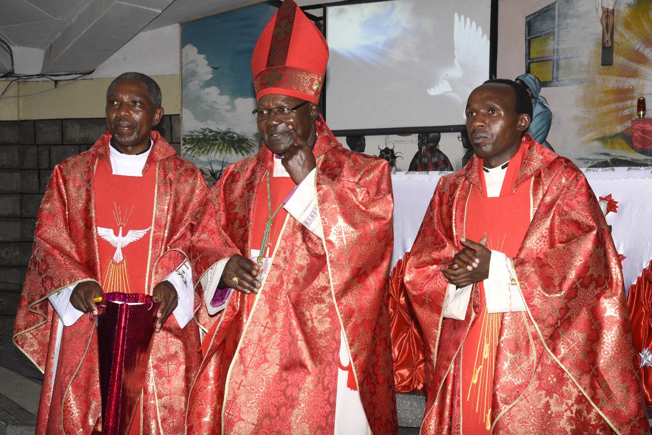 Three clergy members in red vestments during a special celebration, representing the current vibrant parish life