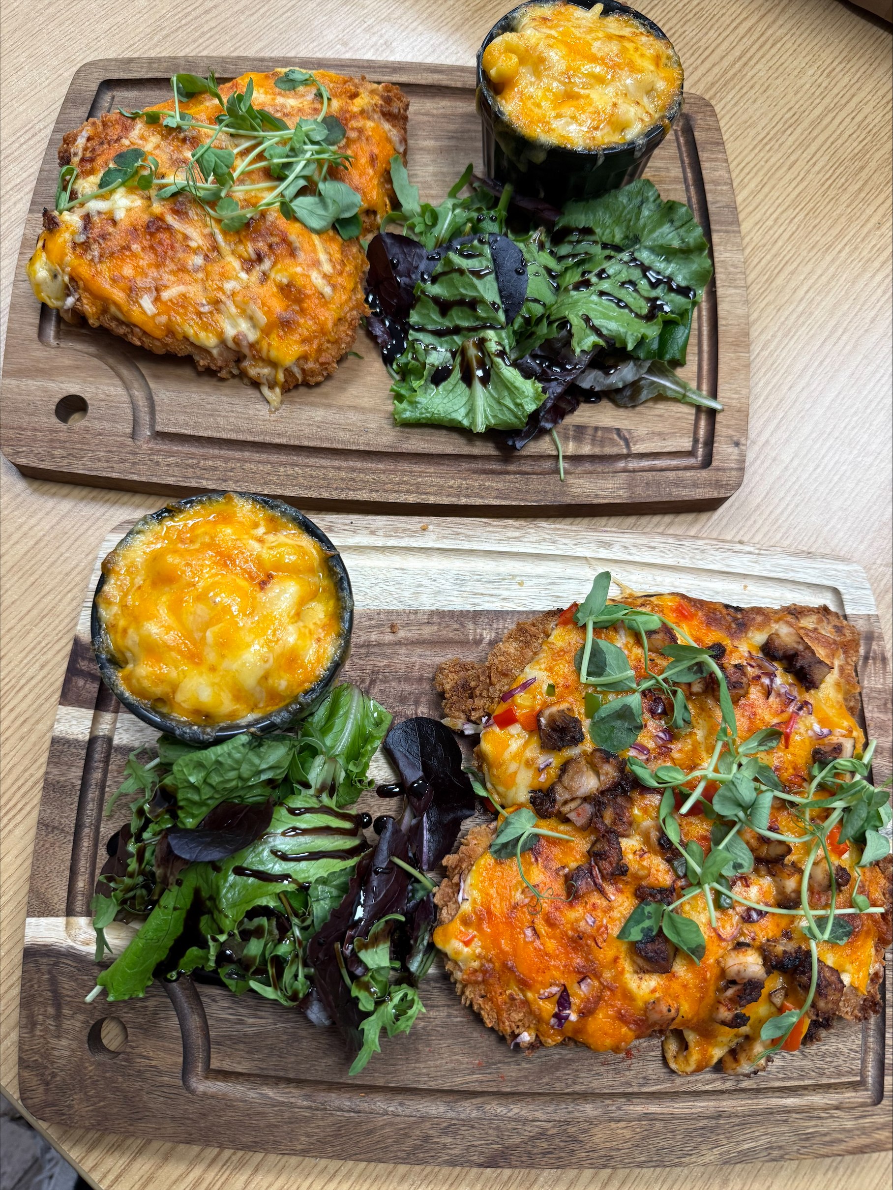 Two parmo boards with mac cheese and dressed salad